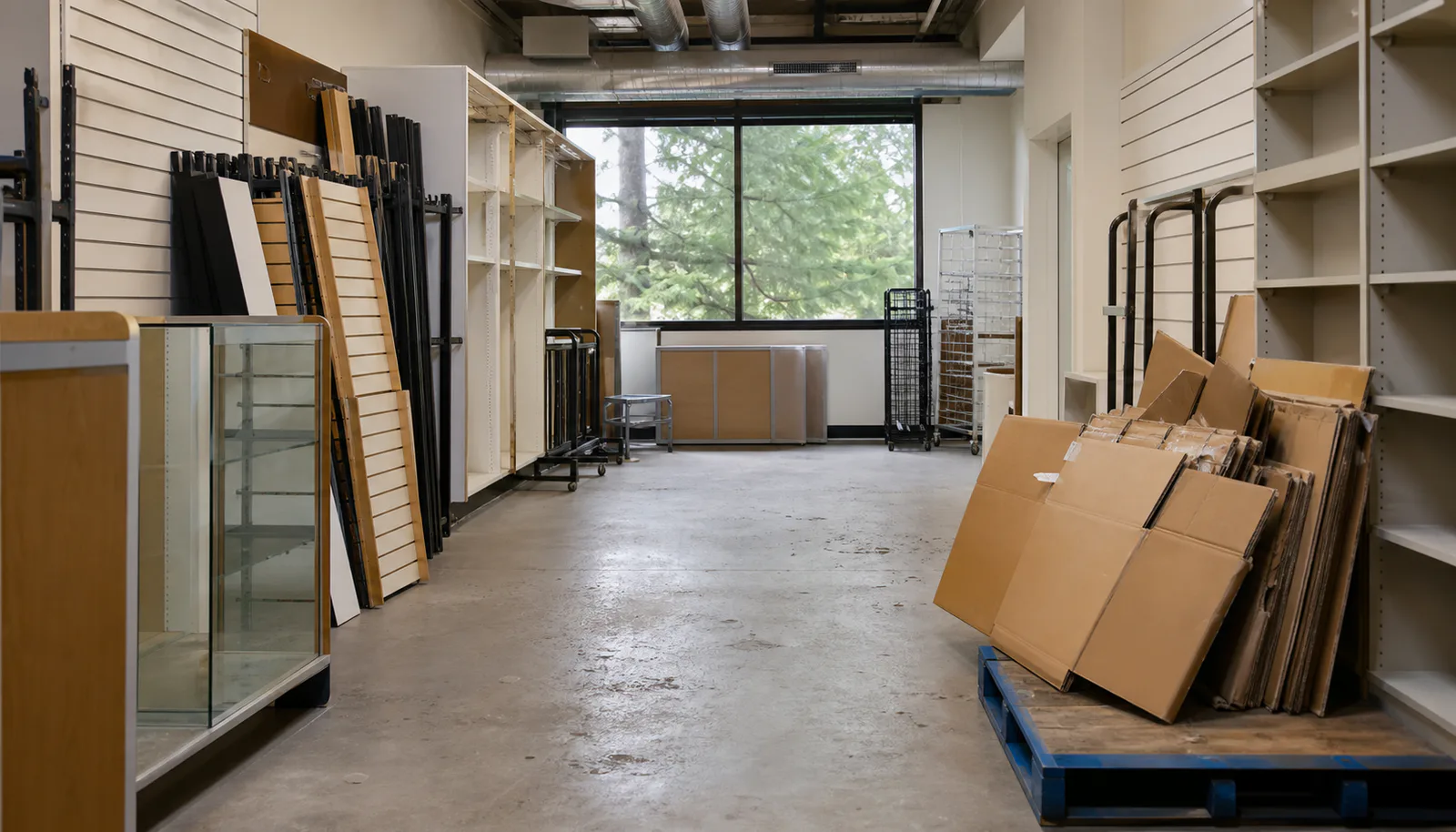 Generic retail reset context with shelving, fixtures, carts, and flattened cardboard