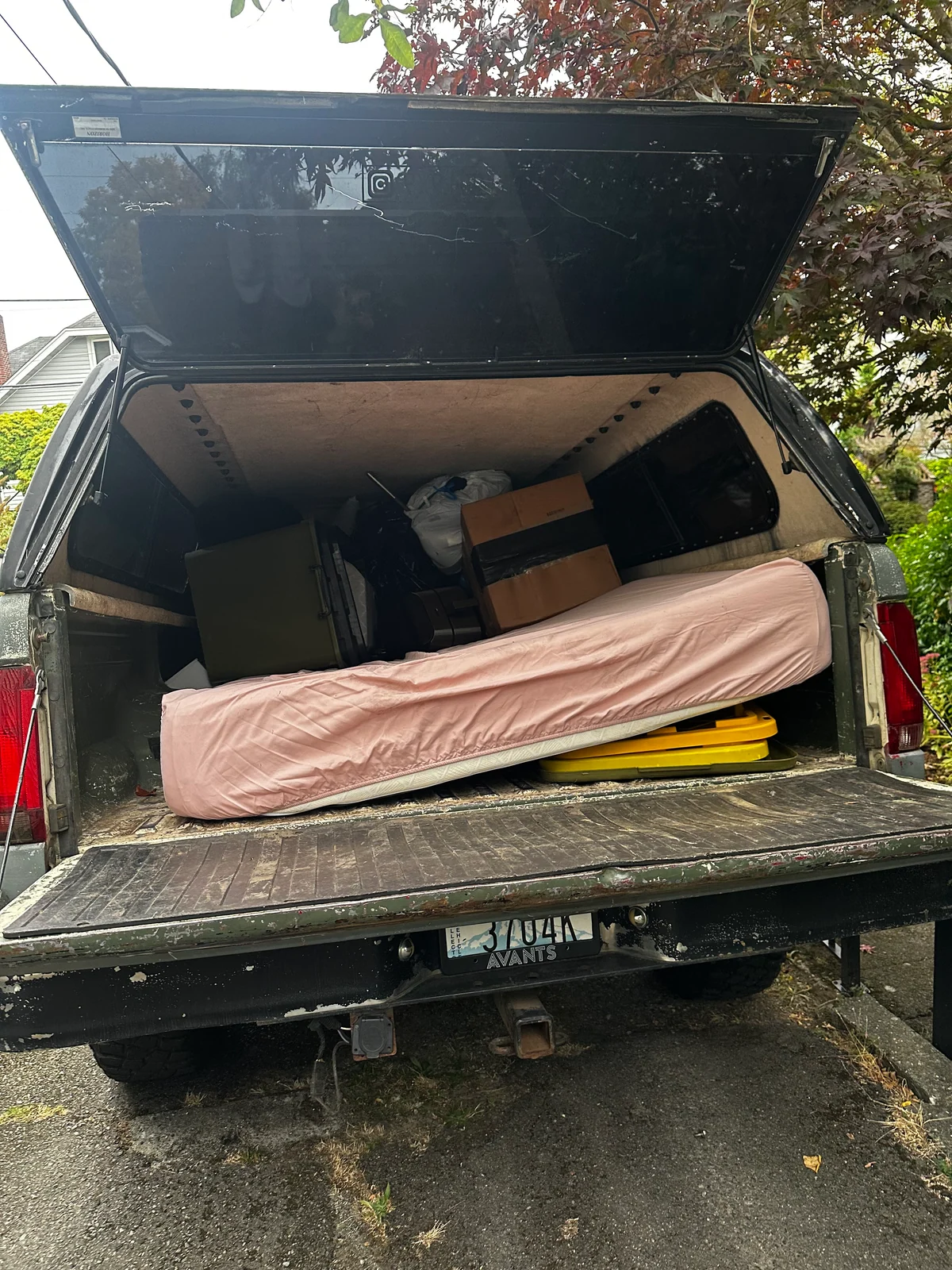 Furniture and move-out items loaded into a pickup truck