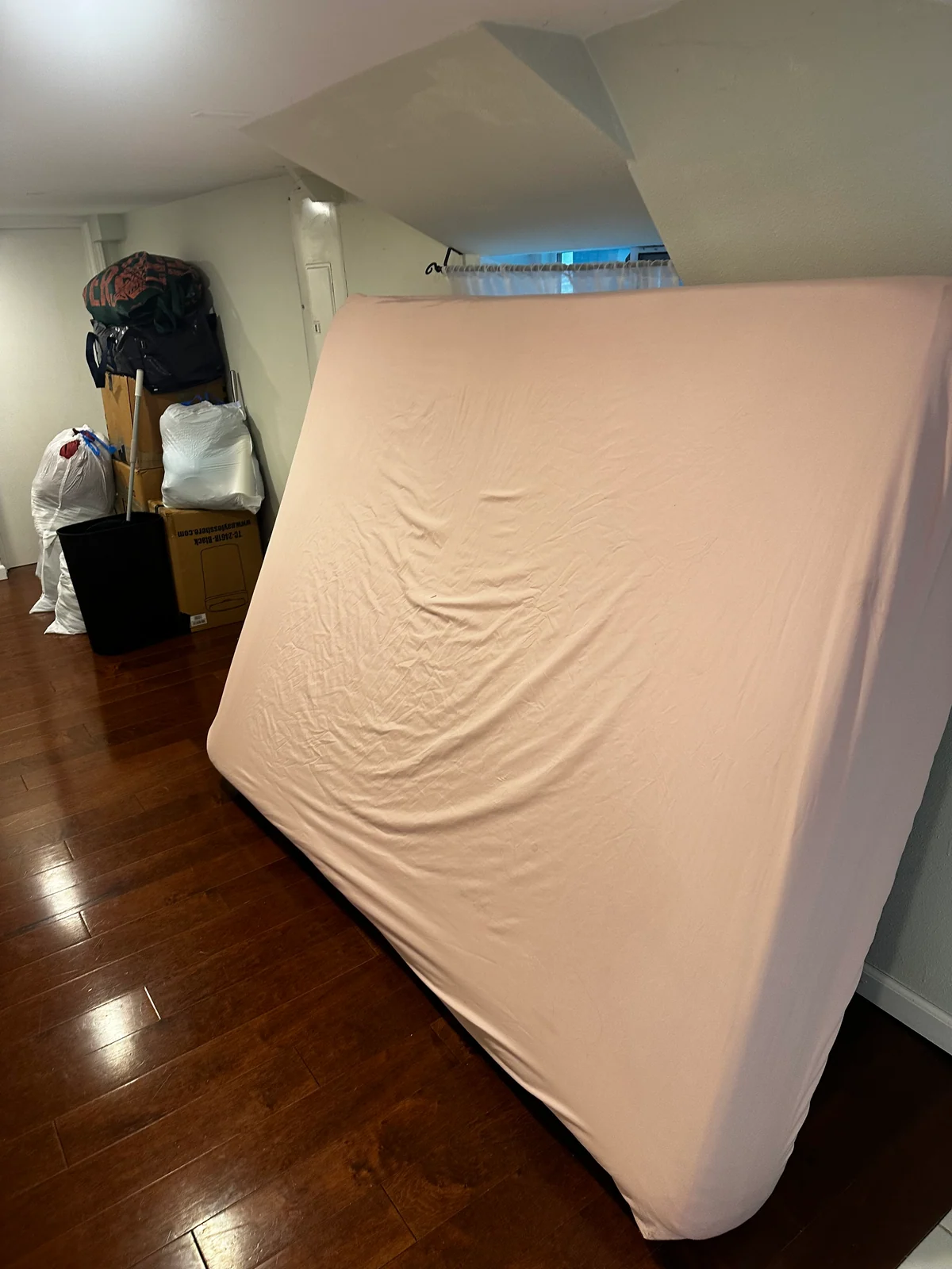 Mattress leaning in a room during the move-out pickup