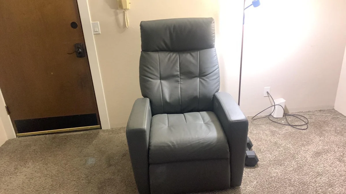 Black recliner documented for furniture pickup