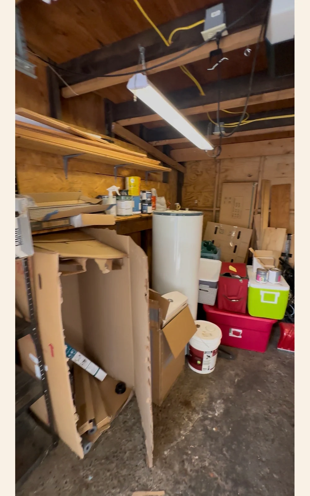 Shelving, cardboard boxes, and loose contents inside the garage
