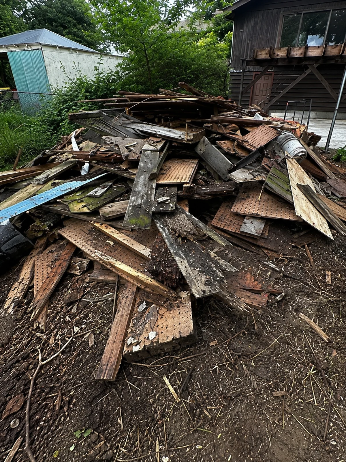 Dismantled shed material gathered in the work area