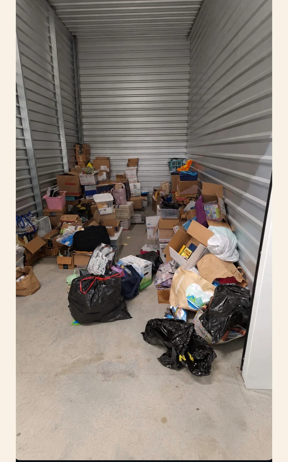 Storage unit containing boxes, bags, and household contents